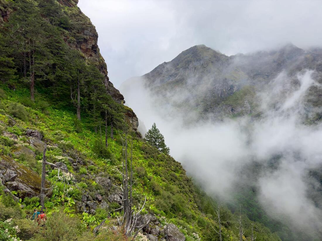 Cloud pouring off the cliff face