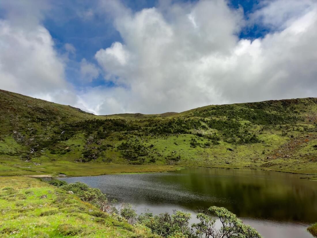 A lake below the green hills