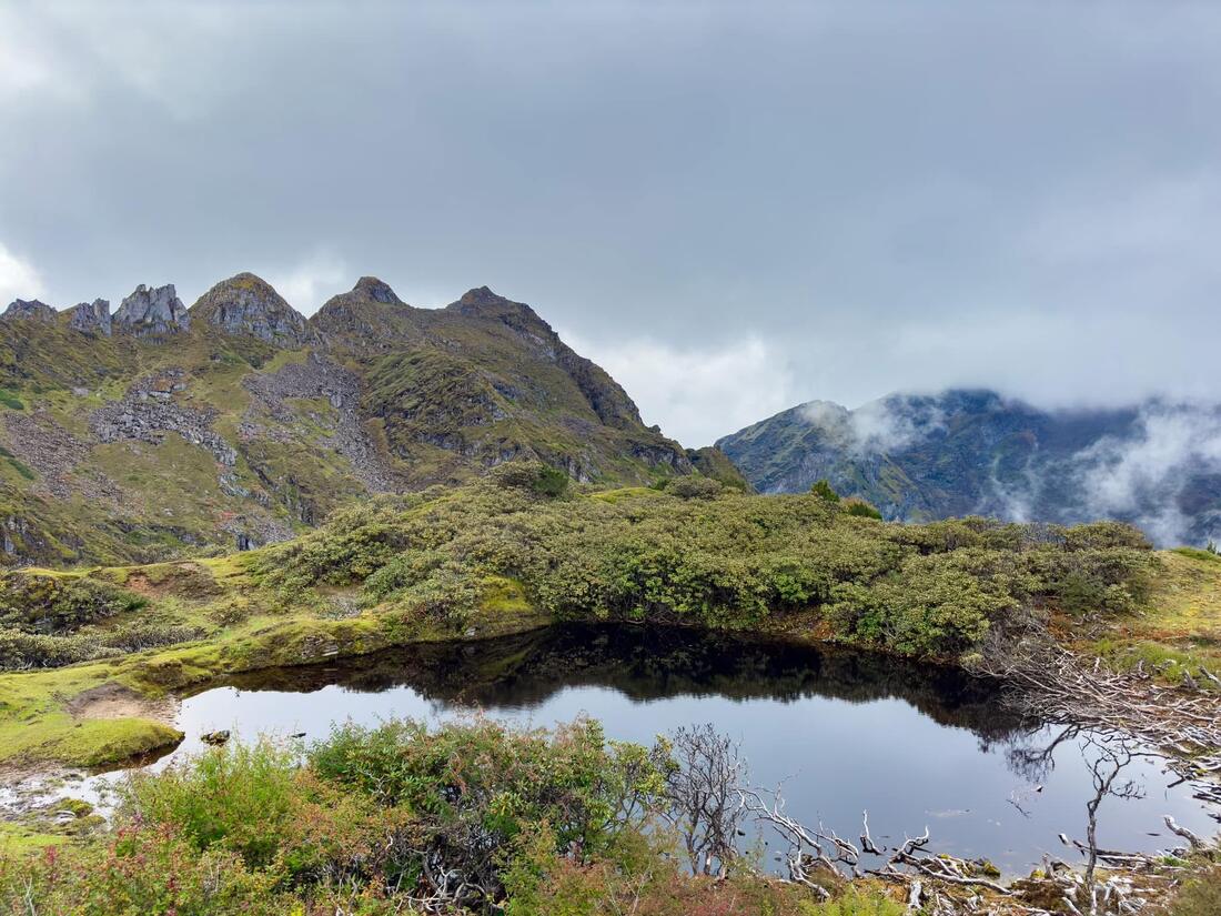 A dark tarn under the rock peaks